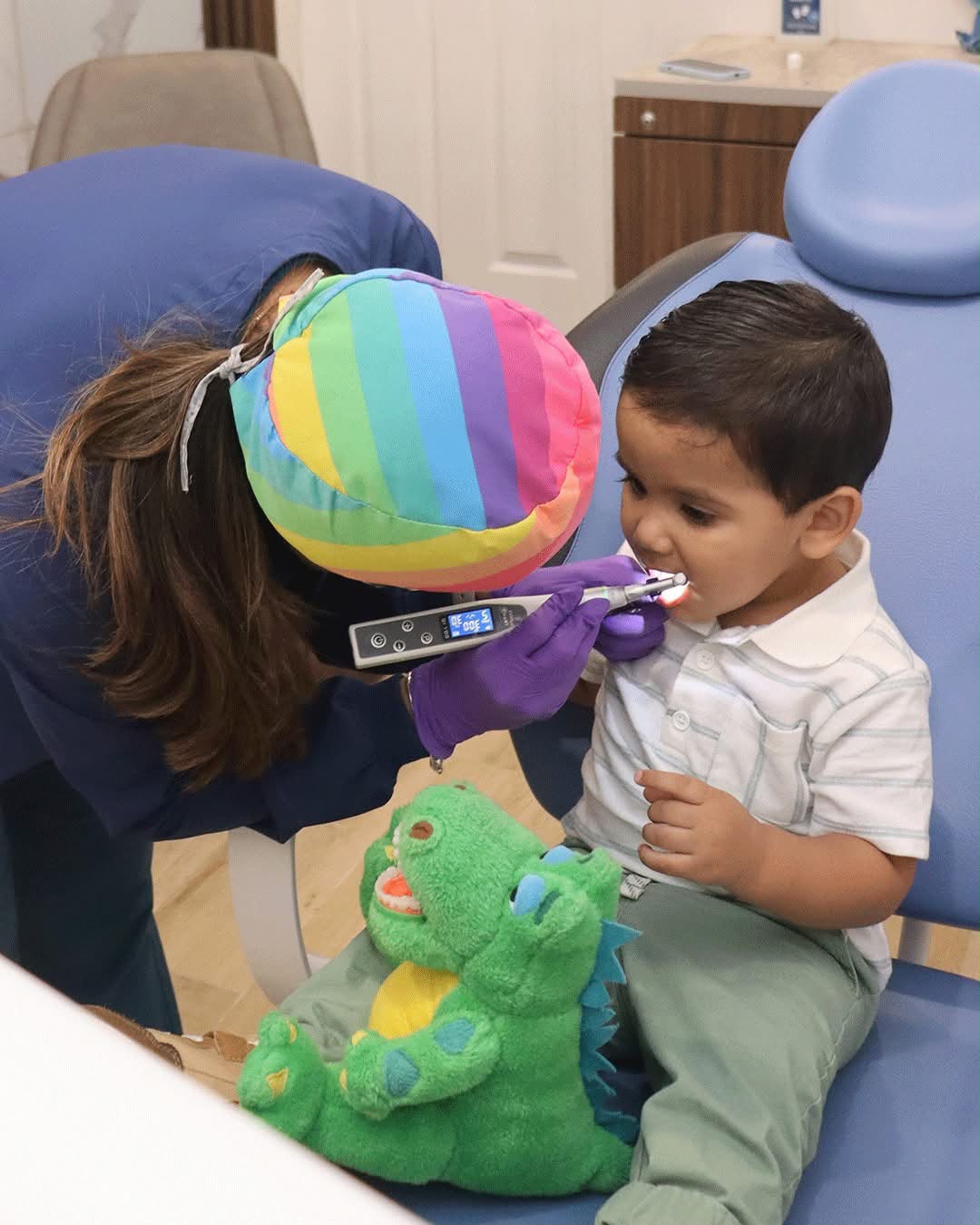 Niño recibiendo revisión dental con mascota